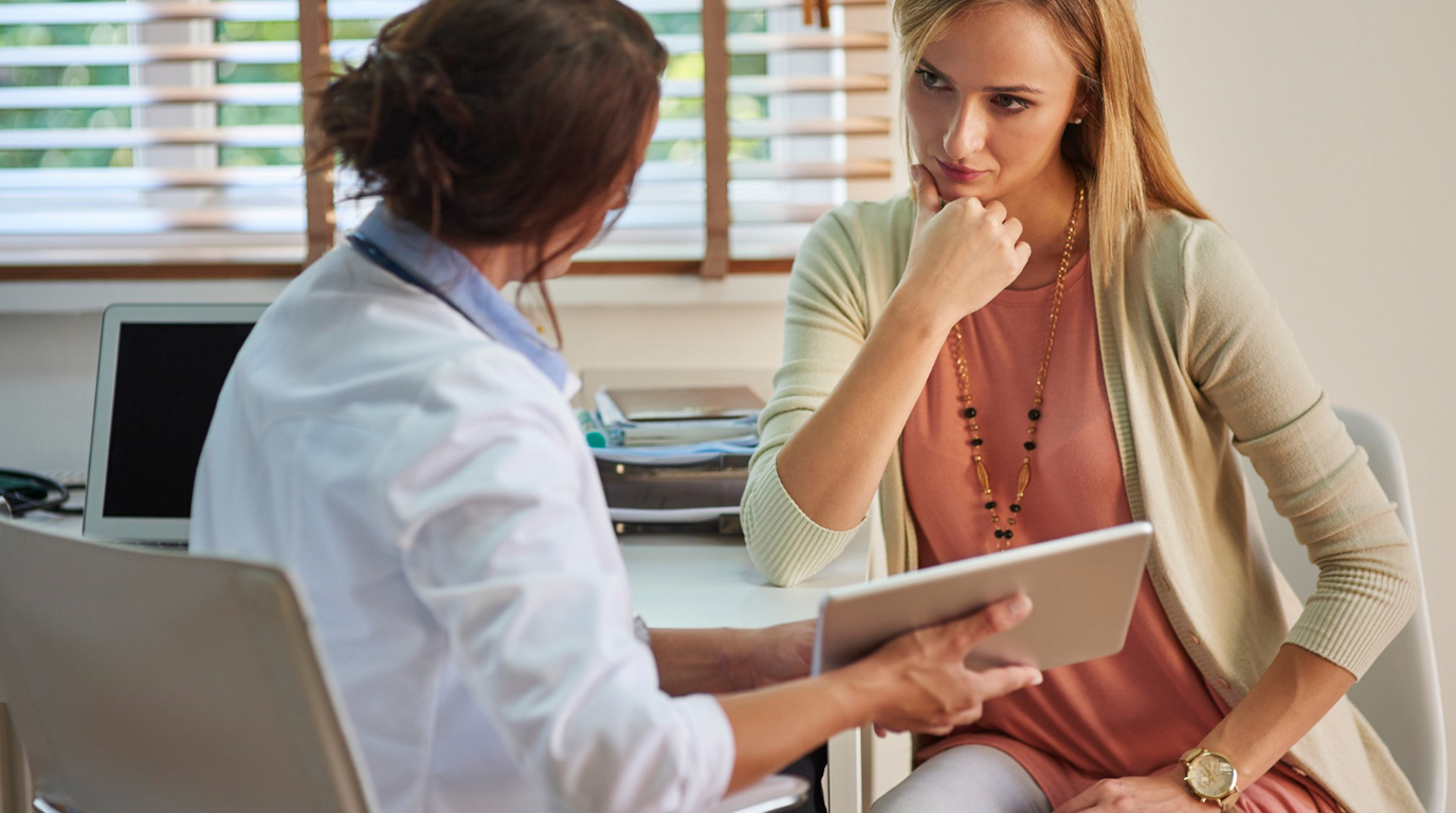 Clinician discussing results on a tablet with a patient