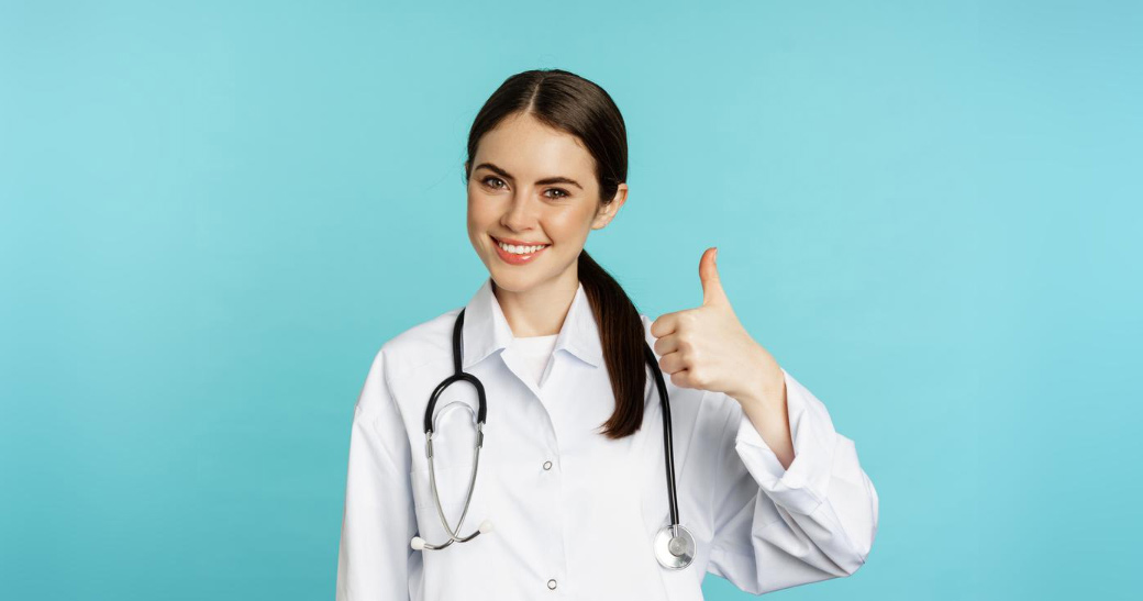 Smiling pediatric physician giving a thumbs-up
