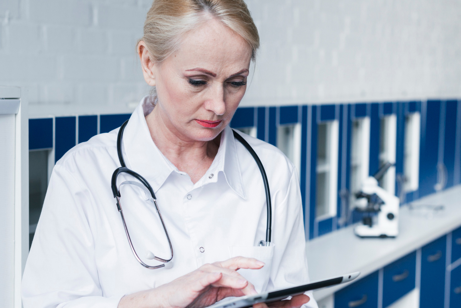 Clinician reviewing shared records on a tablet