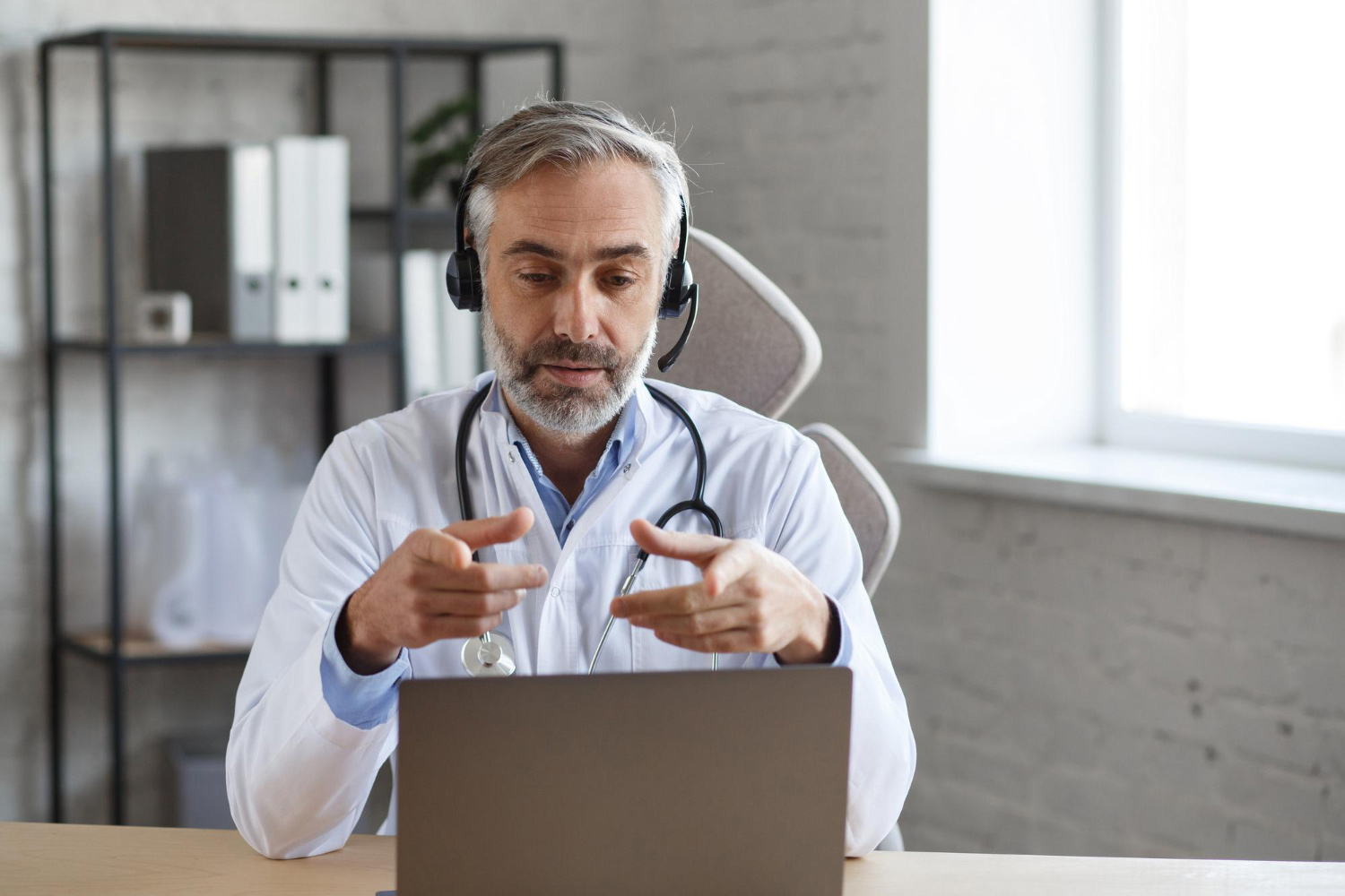 Physician wearing a headset during a video consultation
